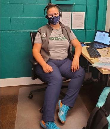 Photo of Jessie Dirks at desk wearing a mask